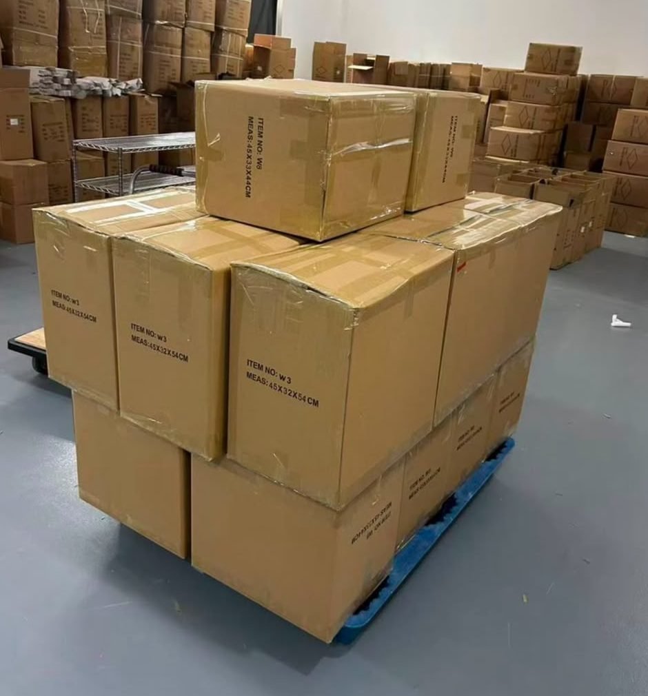 Cartons of OMBRELLAS umbrellas stacked on a pallet in the warehouse